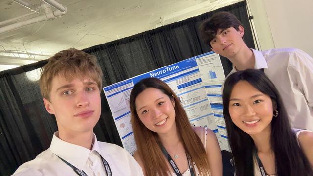Evan Morris with fellow National STEM Festival champions in front of his NeuroTune poster