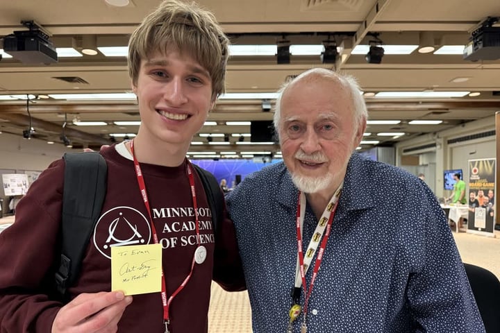 Evan Morris with Art Fry, inventor of the Post-it Note, holding a Post-it that Fry signed to him