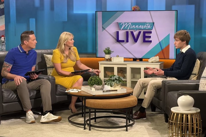 Evan Morris being interviewed by two hosts on the set of Minnesota Live